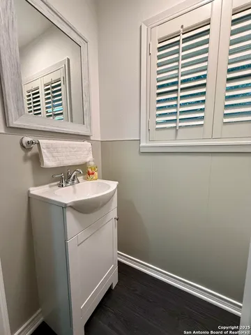 a bathroom with a sink a vanity and a window