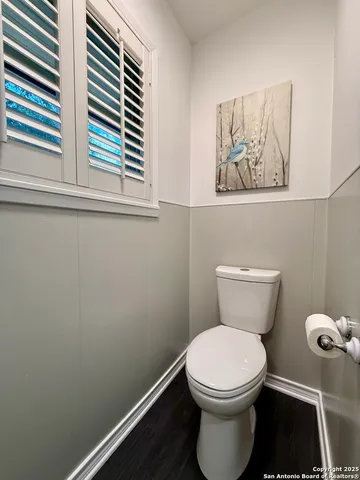 a bathroom with a toilet and a window