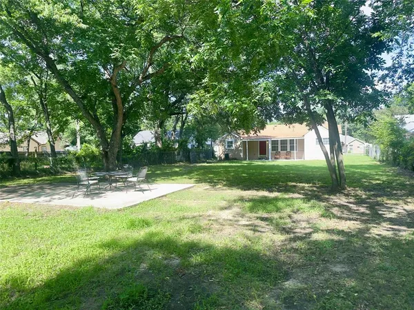 a backyard of a house with yard and trampoline