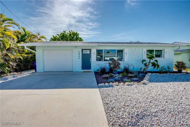 a front view of a house with outdoor seating