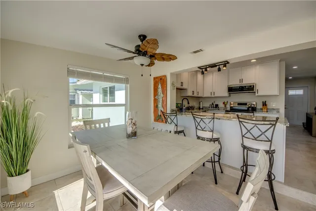 a dining room with furniture and window