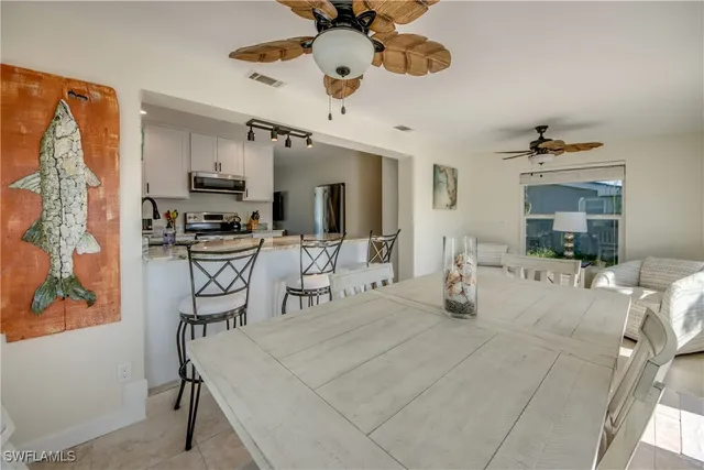 a view of a livingroom with furniture and a ceiling fan