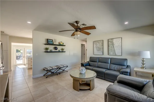 a living room with furniture a ceiling fan and a rug