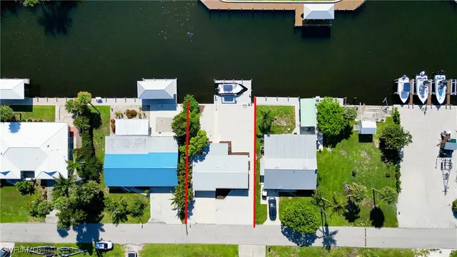 an aerial view of a house with outdoor space and lake view