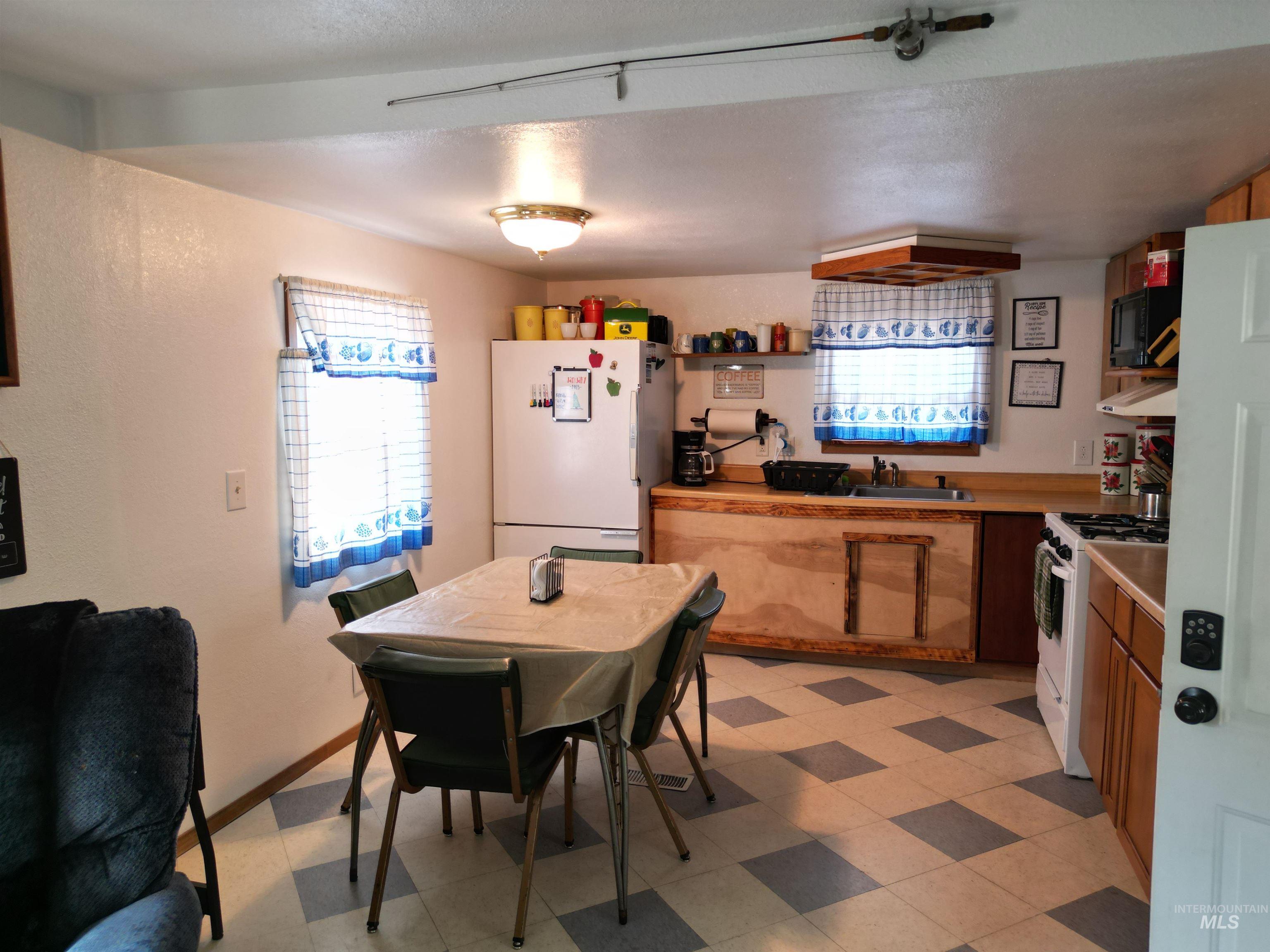 8395 Highway 21 Lowman, ID 83637 - Photo 11 of 22 Kitchen featuring white appliances, light countertops, plenty of natural light, light flooring, and a textured ceiling