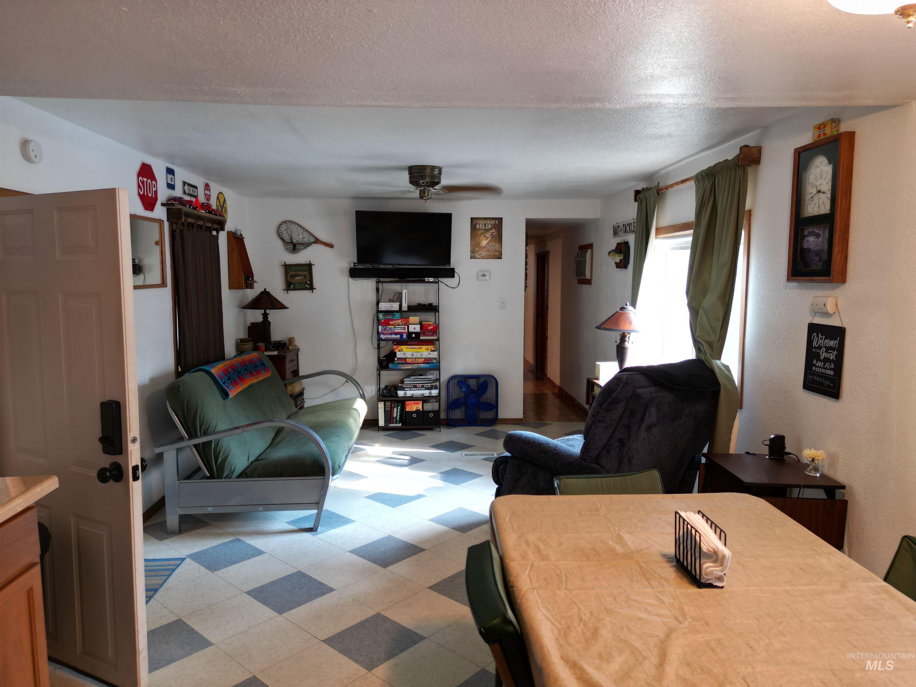 8395 Highway 21 Lowman, ID 83637 - Photo 12 of 22 Living room featuring light flooring, a textured ceiling, and ceiling fan