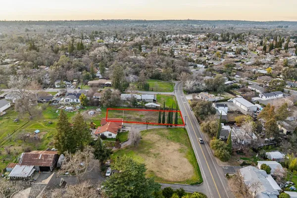 an aerial view of a house with a yard