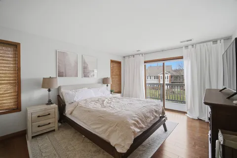 a bedroom with a bed and large window