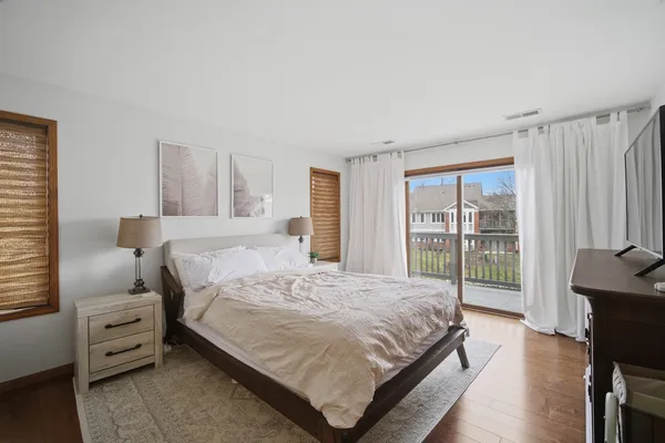 a bedroom with a bed and large window