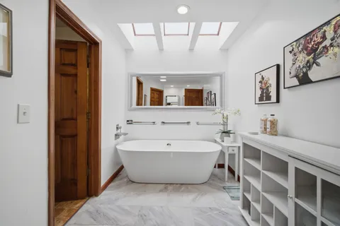 a spacious bathroom with a bathtub and a sink