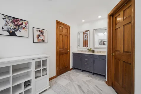 a bathroom with a granite countertop sink mirror and a shower