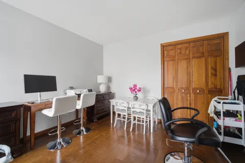 a view of a workspace with furniture and a window