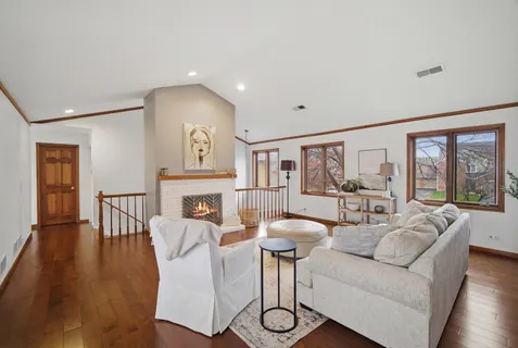 a living room with furniture a dining table and a large window