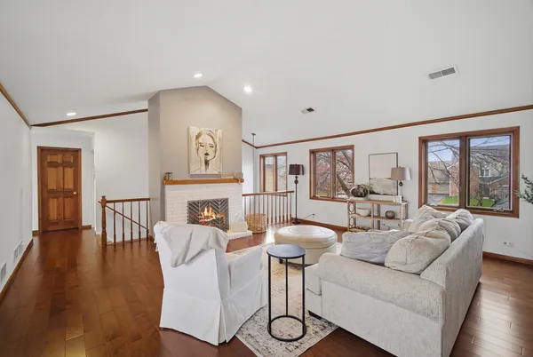 a living room with furniture a dining table and a large window