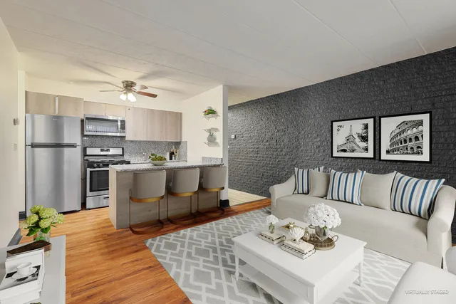 a living room with stainless steel appliances kitchen island granite countertop furniture and a kitchen view