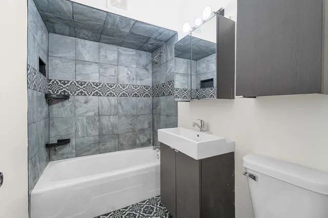 a bathroom with a sink a toilet and bathtub