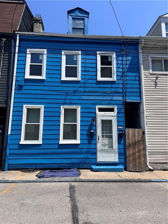 a view of a brick house with a large windows