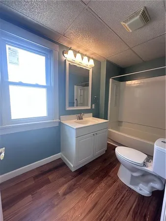 a bathroom with a bathtub sink mirror vanity and toilet