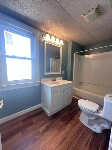 a bathroom with a bathtub sink mirror vanity and toilet