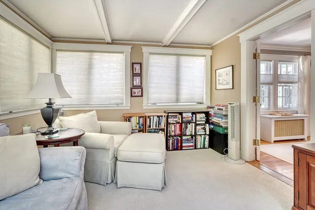 a living room with furniture and large windows