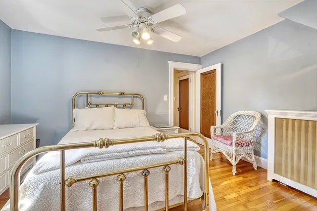 a bedroom with a bed and ceiling fan
