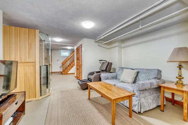 a living room with furniture a couch and a flat screen tv