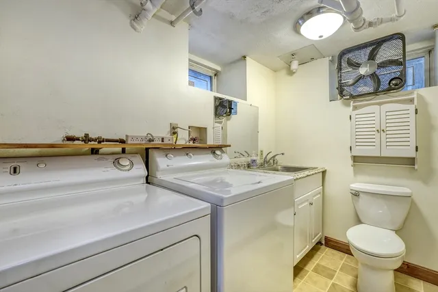 a bathroom with a sink a toilet and mirror