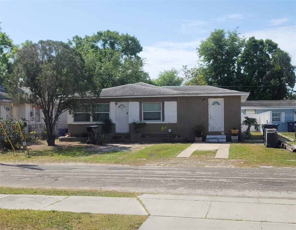 1106 West Arch Street Tampa, FL 33607 - Photo 1 of 2 a front view of a house with a yard