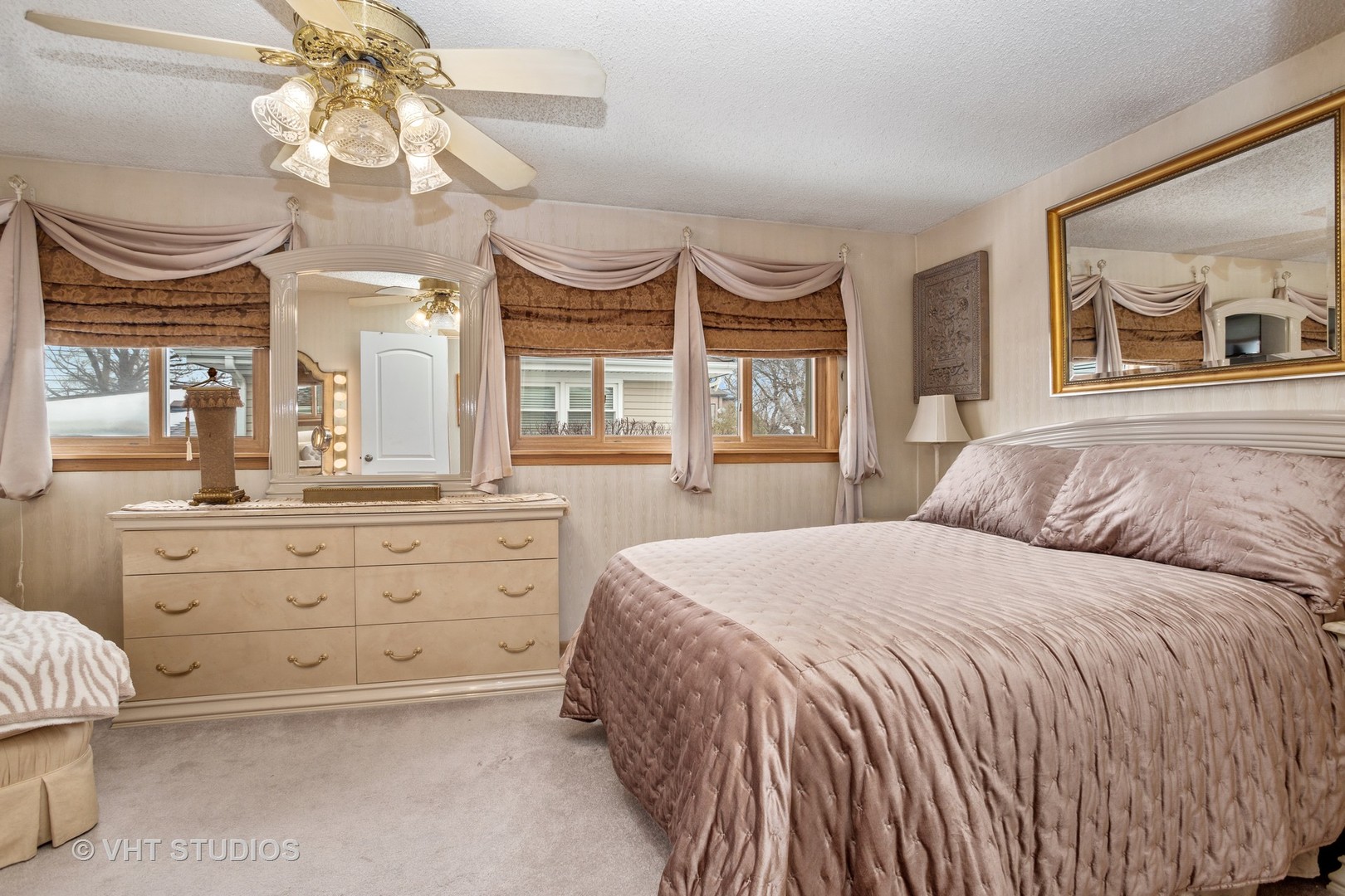 2227 South Wolf Road Des Plaines, IL 60018 - Photo 8 of 24 a spacious bedroom with a large bed and a chandelier