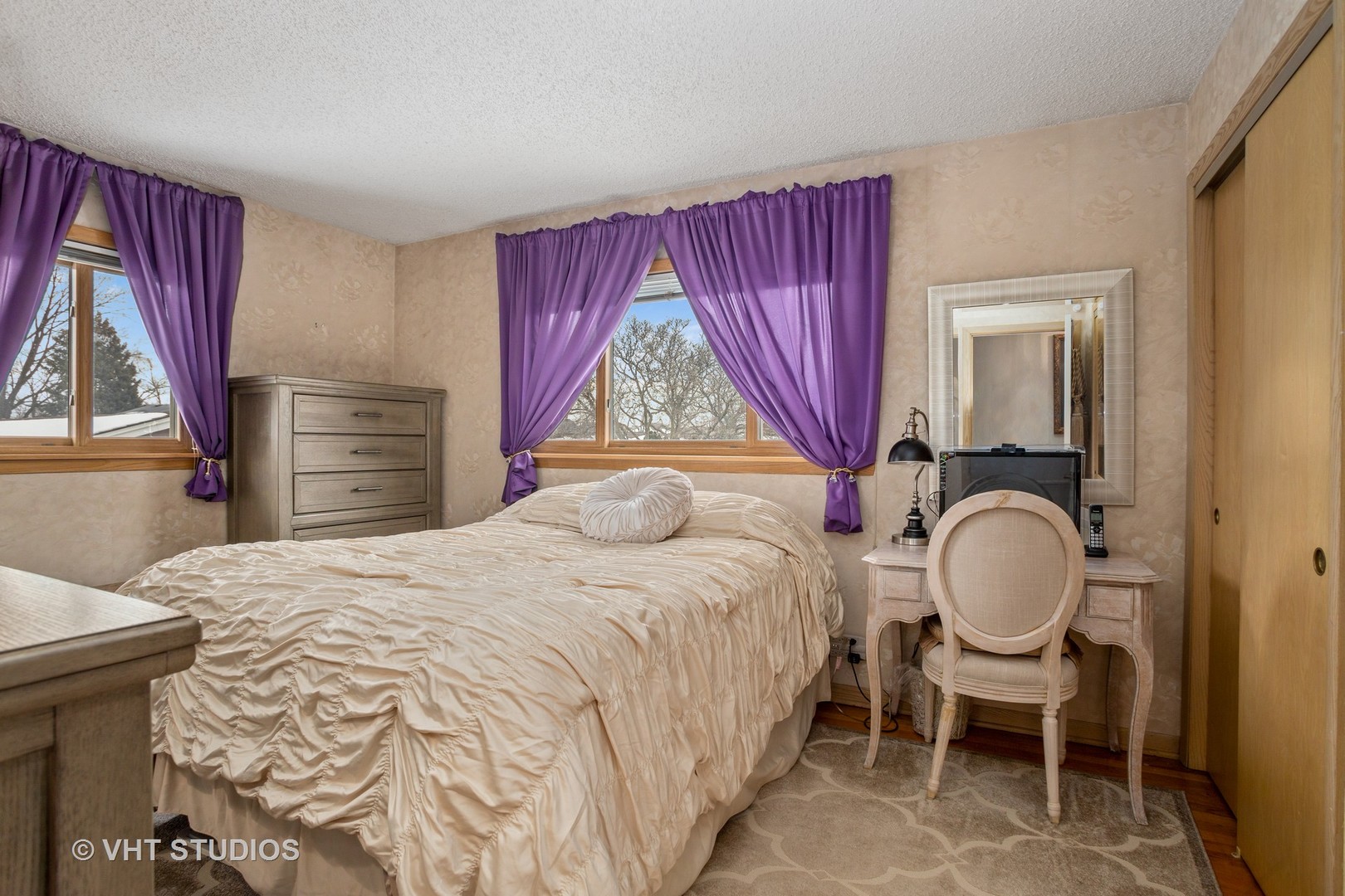 2227 South Wolf Road Des Plaines, IL 60018 - Photo 10 of 24 a bedroom with a bed and a chair