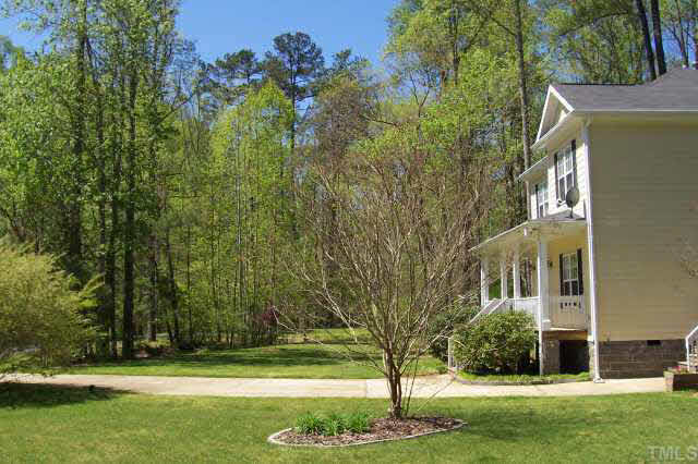3806 Whispering Branch Road Raleigh, NC 27613 - Photo 2 of 9 a view of a tree in front of a house