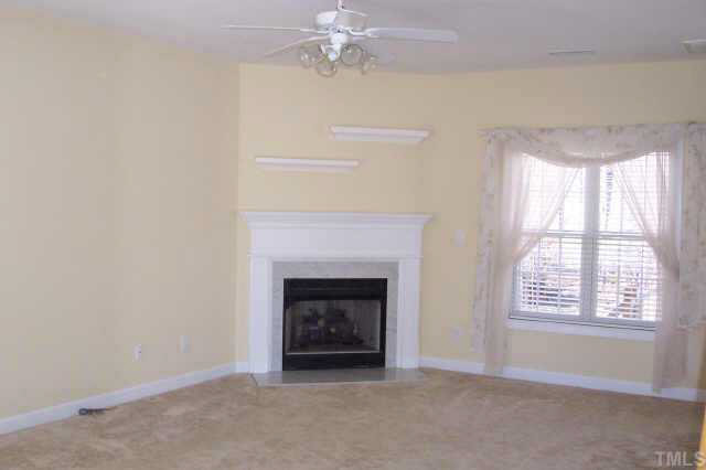 3806 Whispering Branch Road Raleigh, NC 27613 - Photo 5 of 9 a living room with furniture and a fireplace