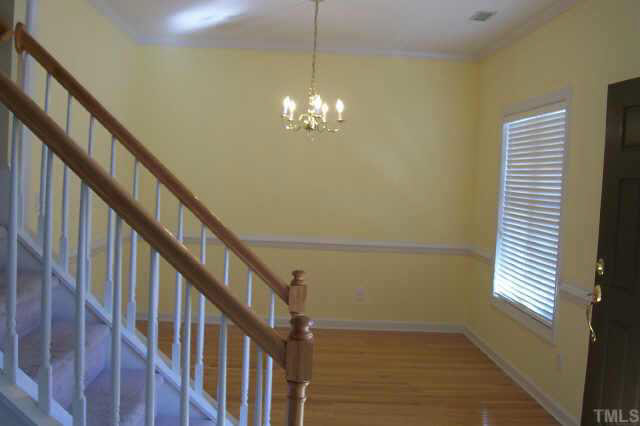 3806 Whispering Branch Road Raleigh, NC 27613 - Photo 6 of 9 a view of a room with wooden floor and stairs