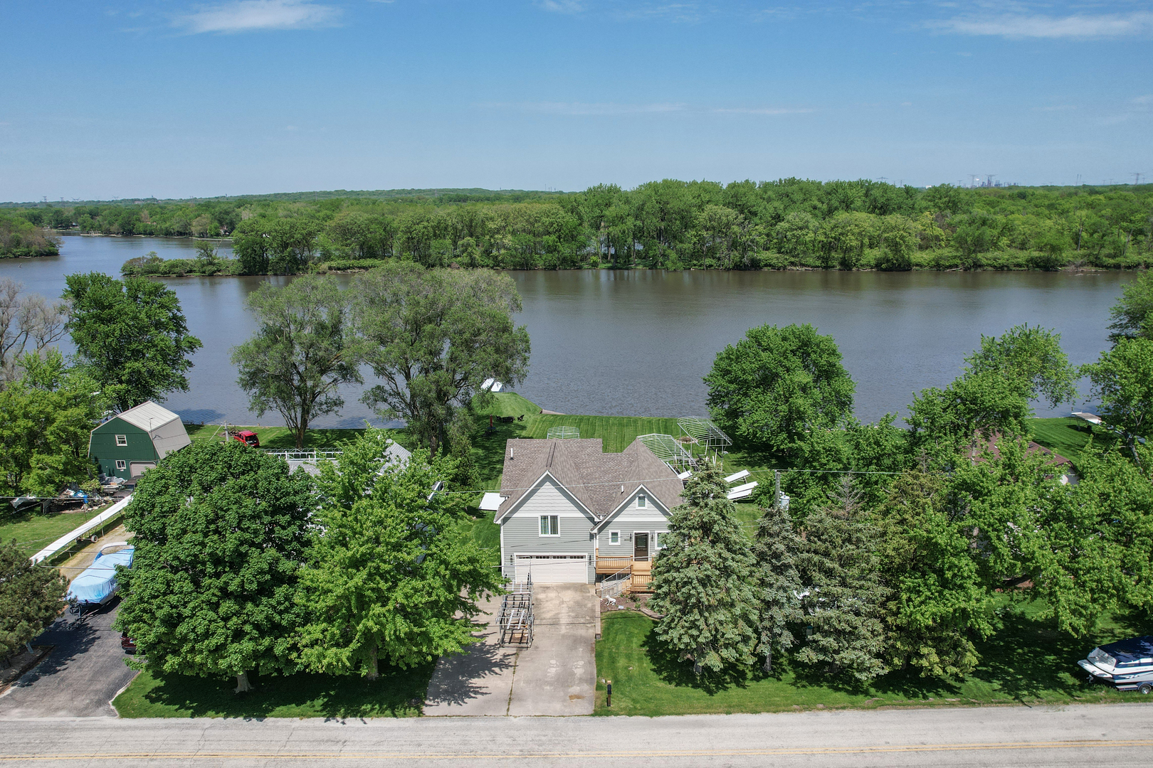 an aerial view of a house with outdoor space and lake view