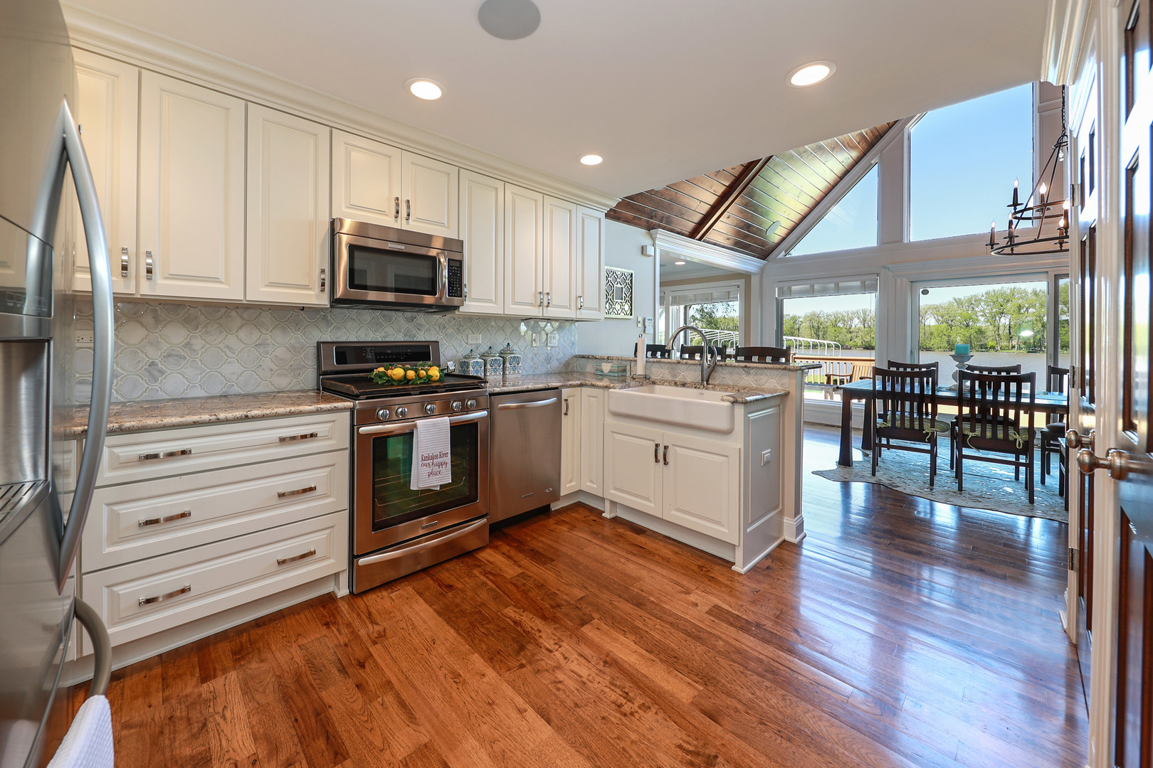 26000 Cottage Road Wilmington, IL 60481 - Photo 11 of 31 a kitchen with stainless steel appliances kitchen island granite countertop a stove and a view of living room