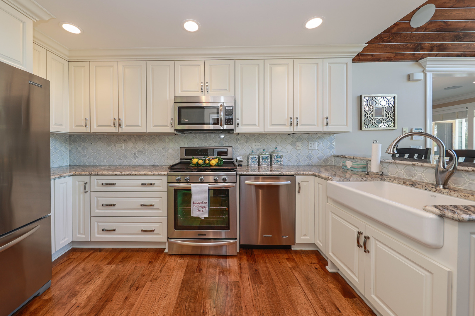 26000 Cottage Road Wilmington, IL 60481 - Photo 12 of 31 a kitchen with granite countertop a sink cabinets stainless steel appliances and a counter space