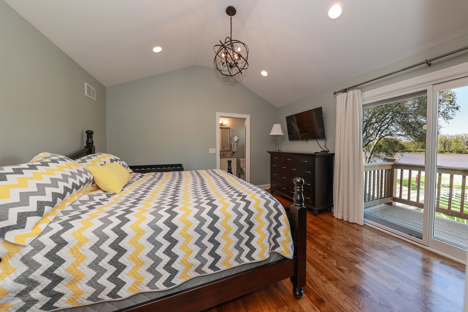 26000 Cottage Road Wilmington, IL 60481 - Photo 18 of 31 a bedroom with a large bed and a fireplace