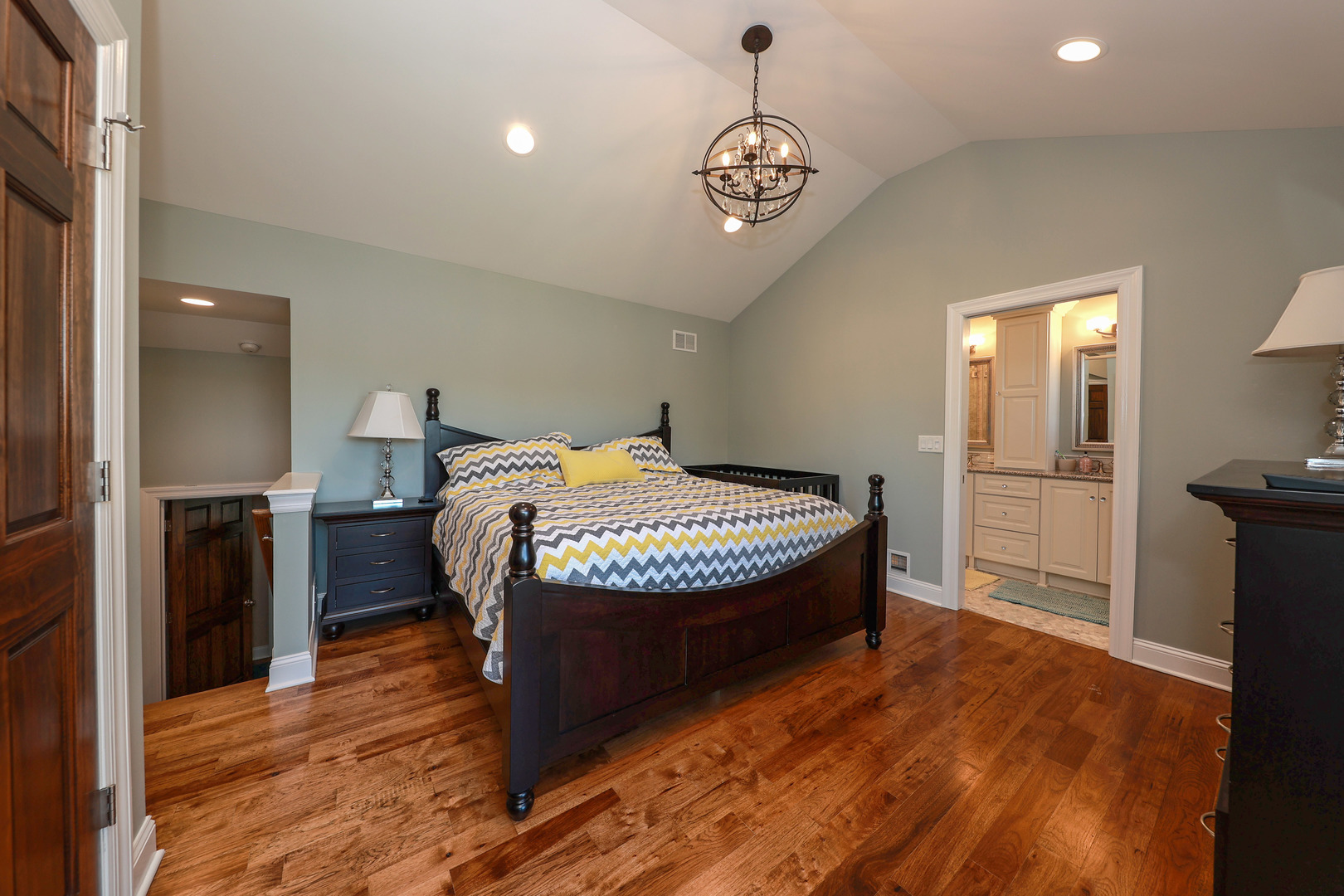 26000 Cottage Road Wilmington, IL 60481 - Photo 19 of 31 a bedroom with a bed and a chandelier