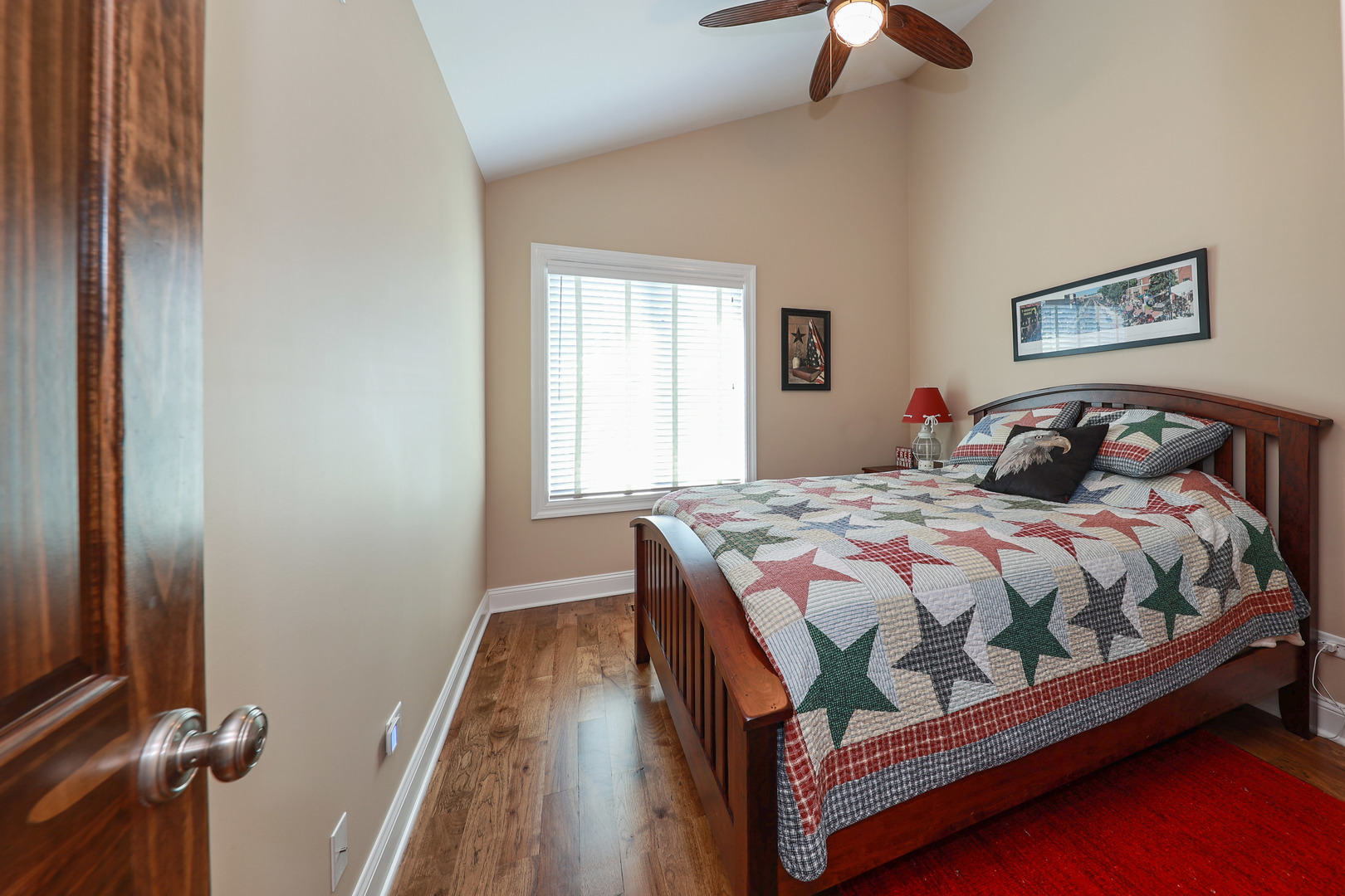 26000 Cottage Road Wilmington, IL 60481 - Photo 23 of 31 a bedroom with a bed and a chandelier