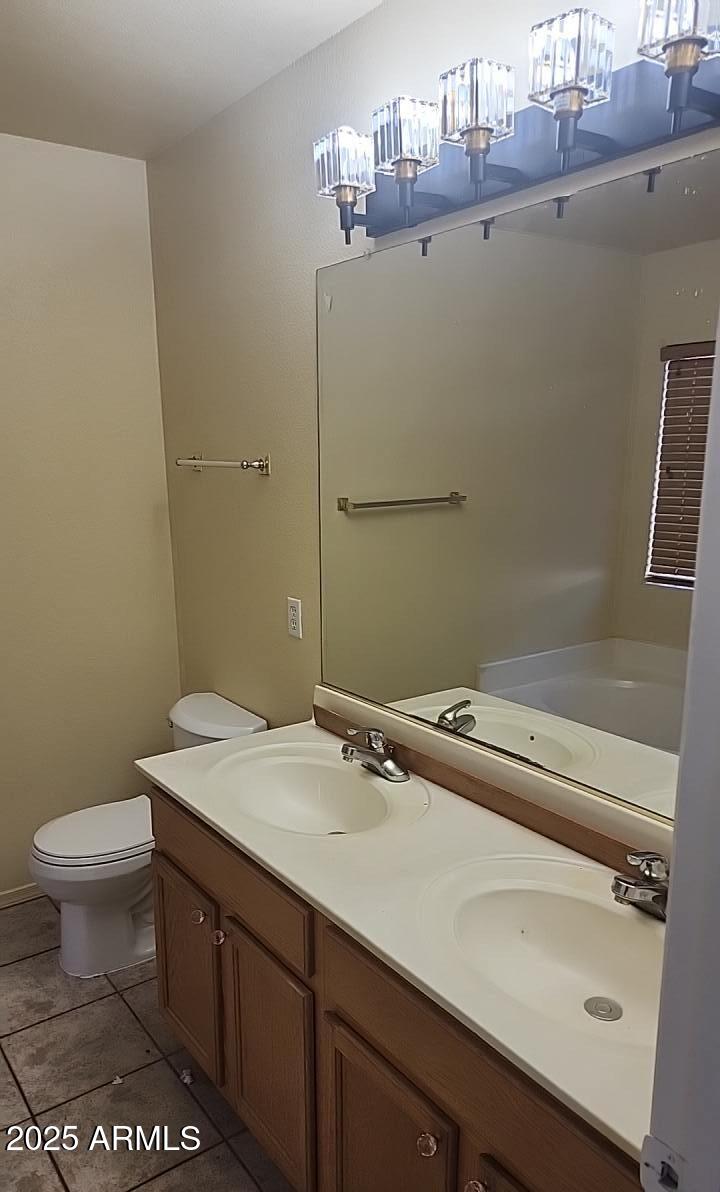 914 East Monterey Street Chandler, AZ 85225 - Photo 12 of 16 a bathroom with a sink a toilet and a mirror