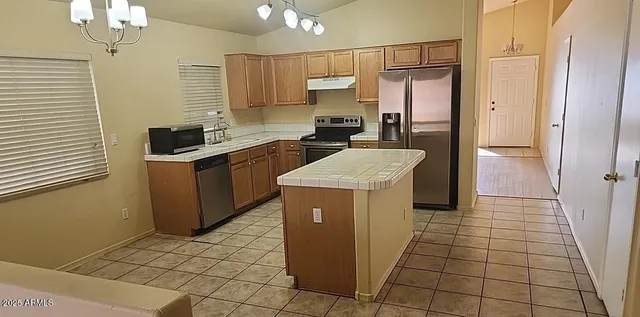 a kitchen with a sink a stove a refrigerator and cabinets