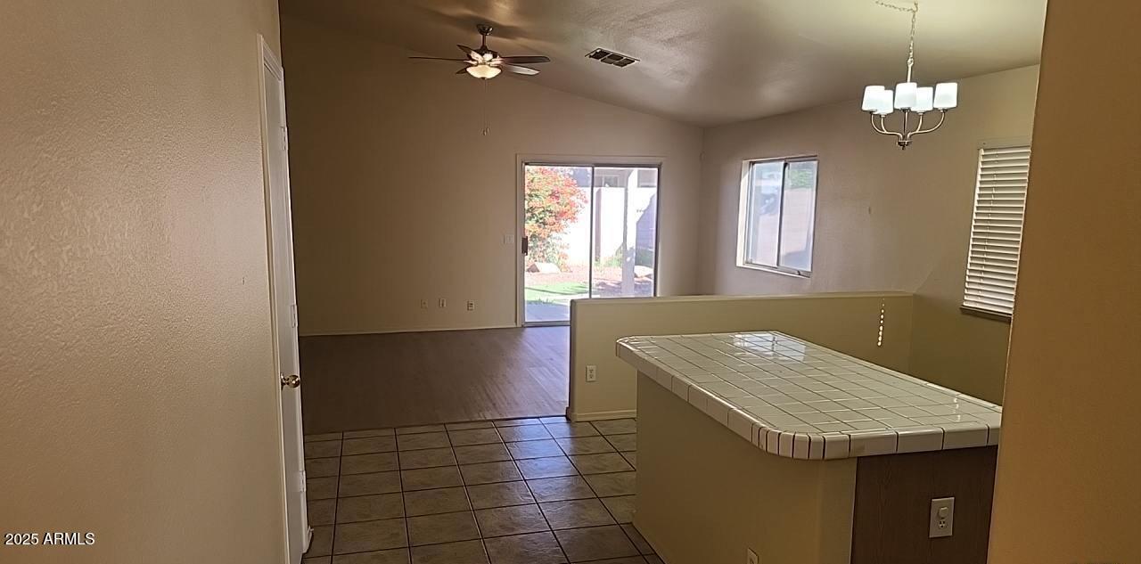 914 East Monterey Street Chandler, AZ 85225 - Photo 4 of 16 a kitchen with a sink a chandelier stainless steel appliances and cabinets