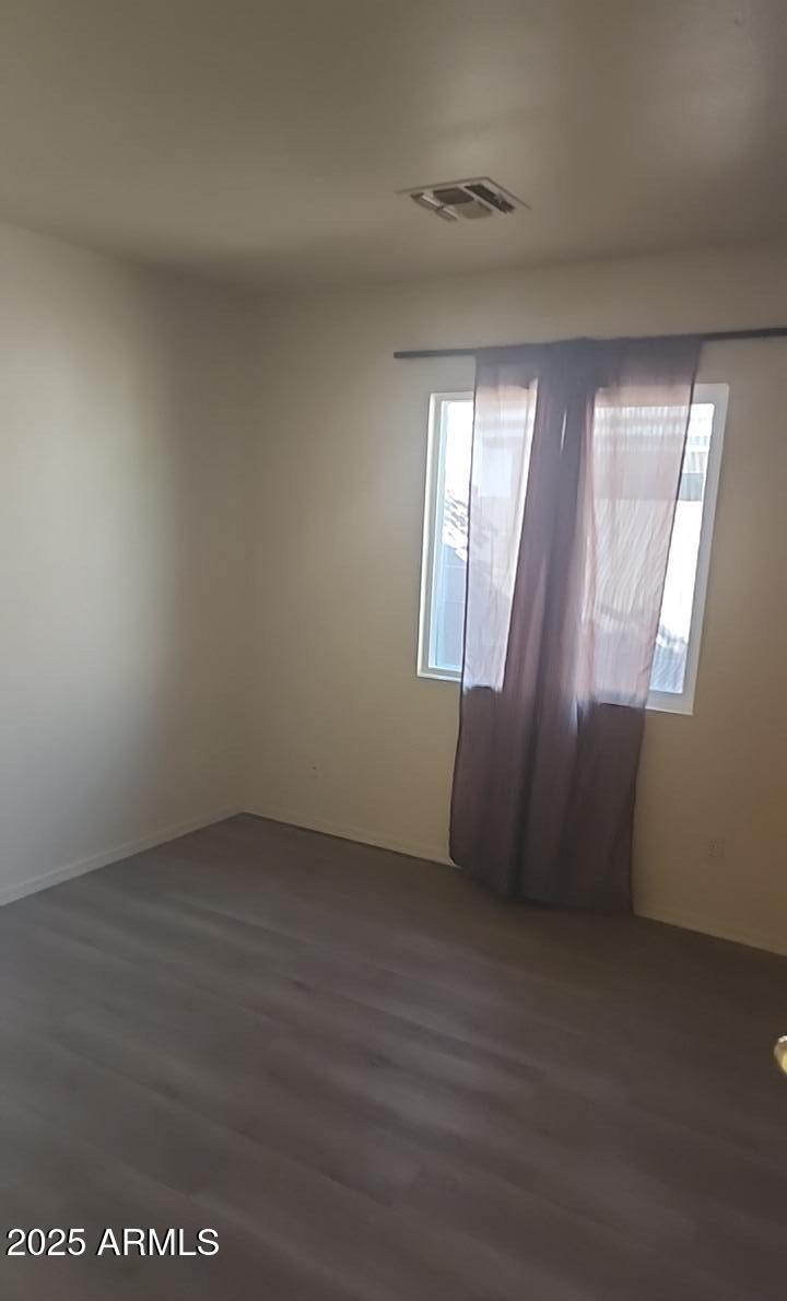 914 East Monterey Street Chandler, AZ 85225 - Photo 7 of 16 an empty room with wooden floor and windows
