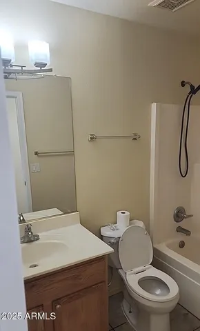 a white toilet sitting next to a bathroom sink and a shower