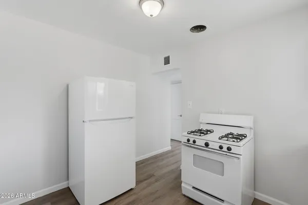 a kitchen with a stove and a refrigerator