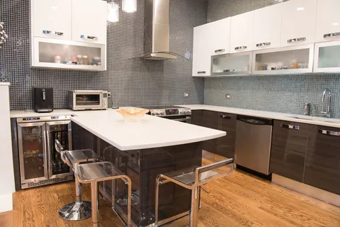 a kitchen with stainless steel appliances a sink a stove a refrigerator and cabinets