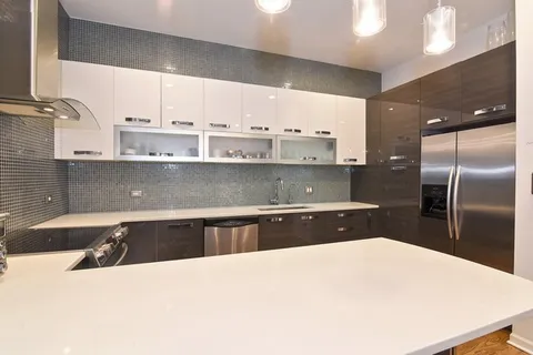 a kitchen with stainless steel appliances a sink a stove and a refrigerator