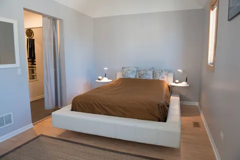 a bedroom with a bed and lamp