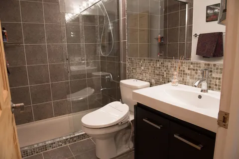 a bathroom with a sink toilet and shower