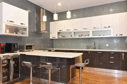 a kitchen with a sink a stove a dining table and chairs